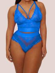 Blue lace lingerie set on a model against a beige background