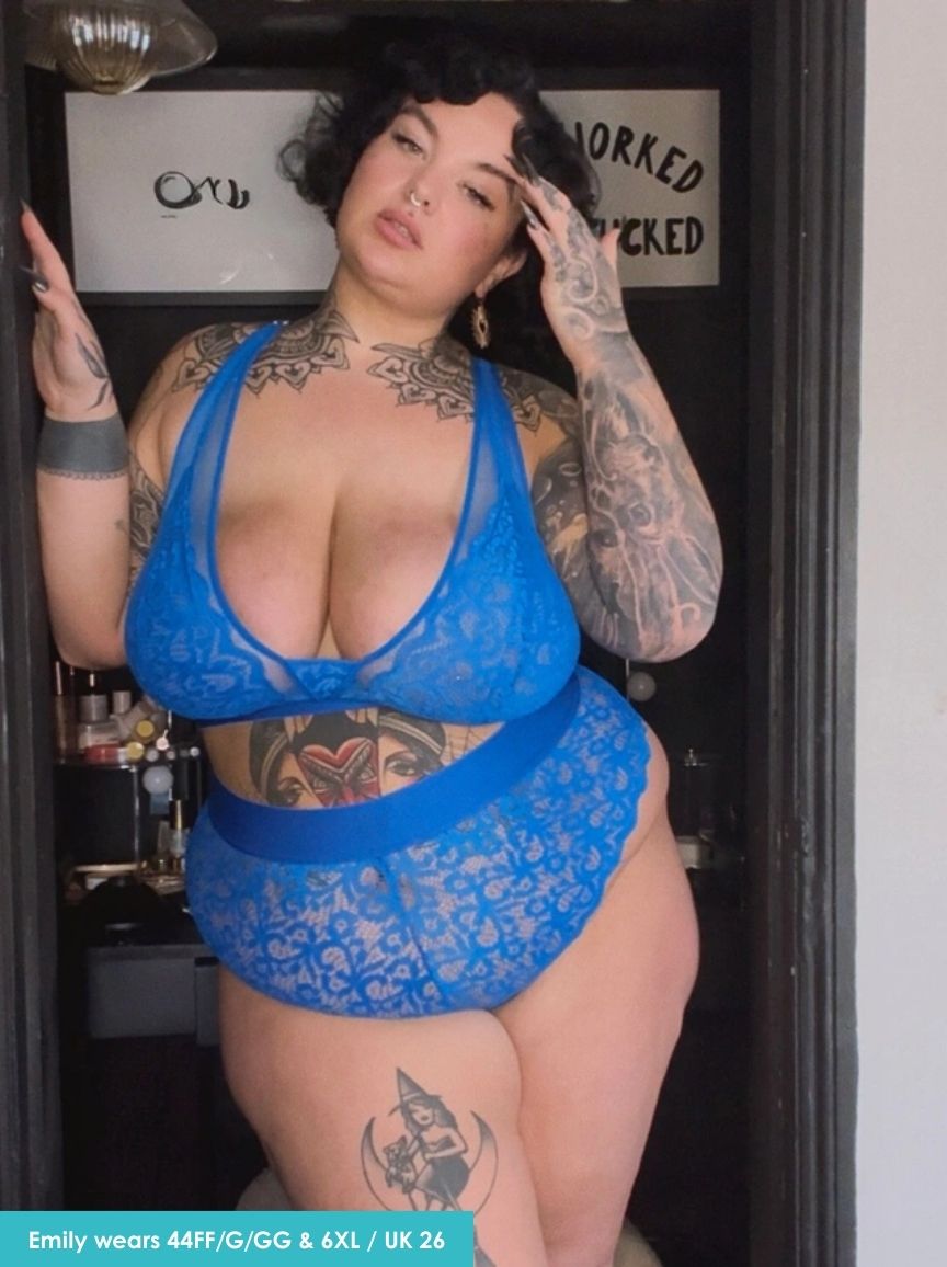 Person wearing a blue lace lingerie set with tattoos visible.